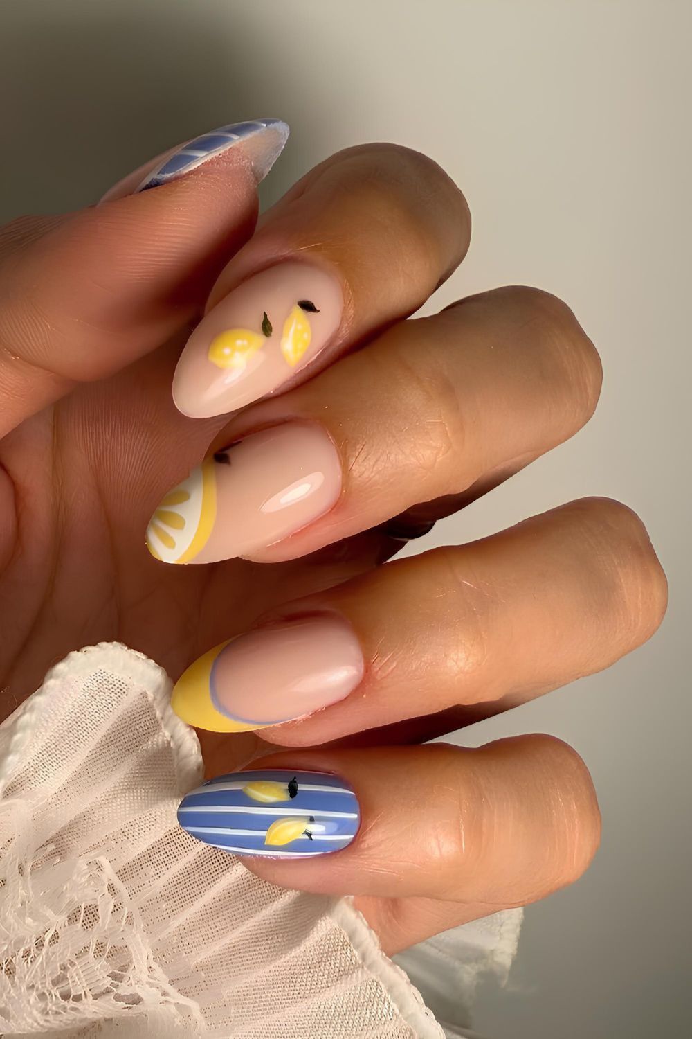 Yellow and blue nails with stripes and lemons