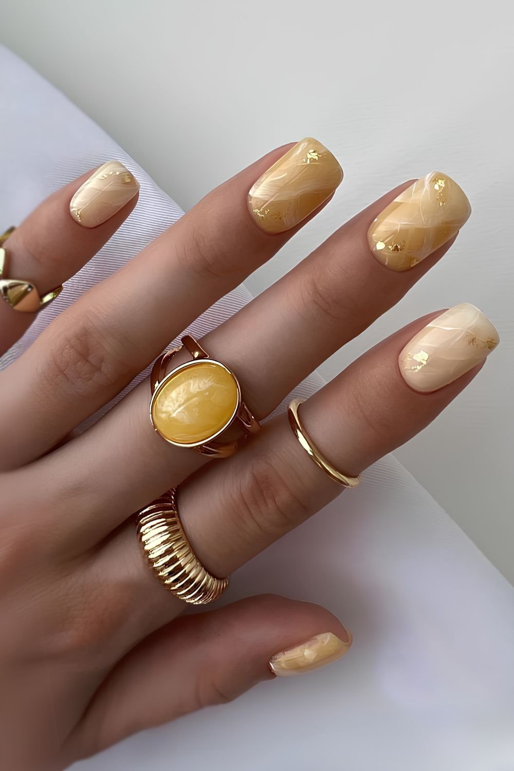 Yellow jade-inspired marble nails