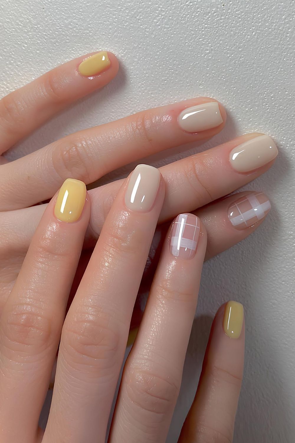 Yellow manicure with plaid art accent