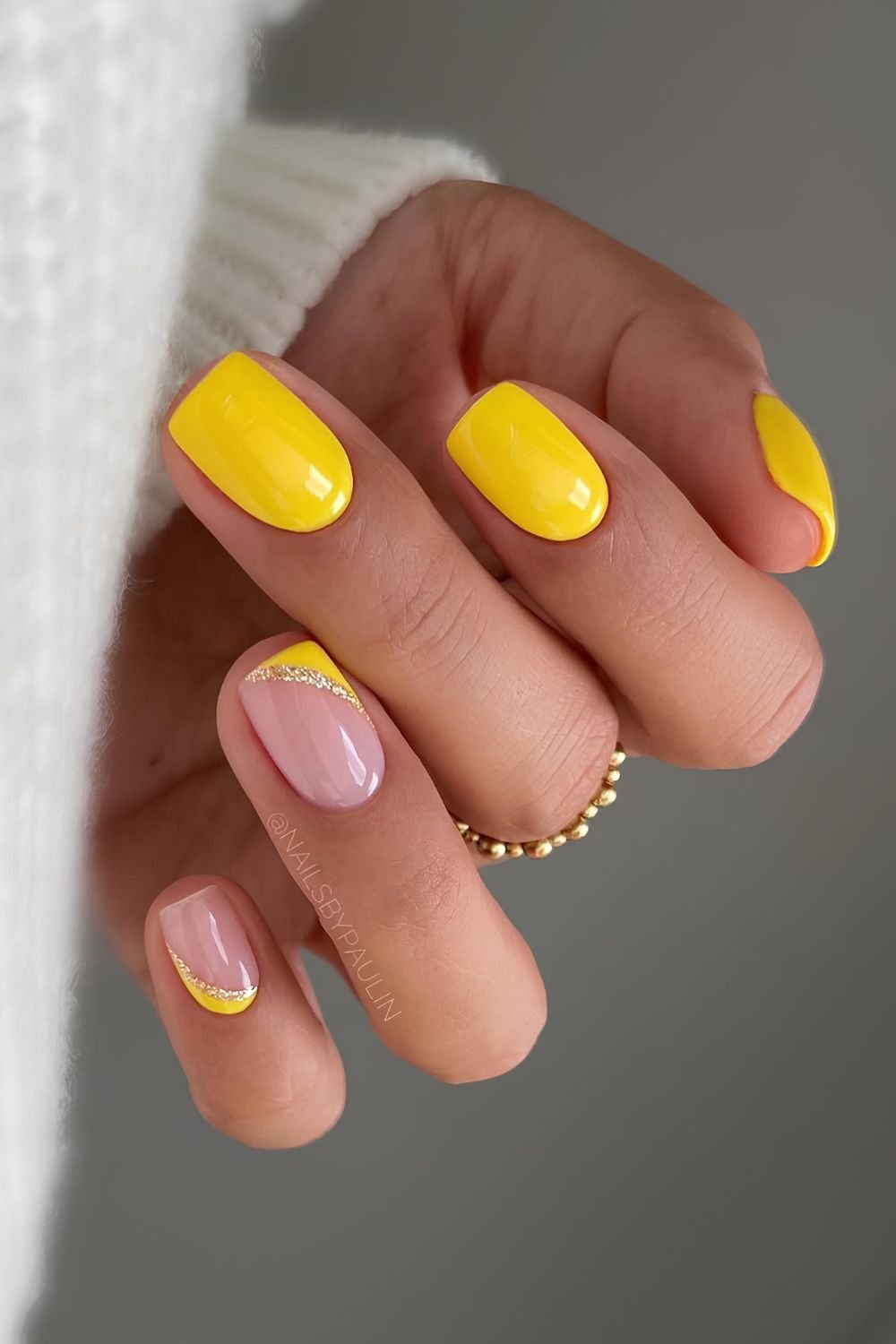 Yellow nails with glitter accents